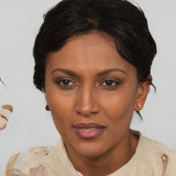 Joyful black adult female with short  brown hair and brown eyes