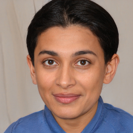 Joyful latino young-adult female with short  brown hair and brown eyes