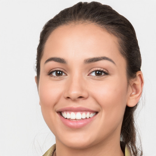 Joyful white young-adult female with long  brown hair and brown eyes