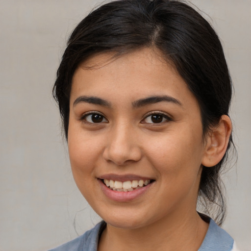 Joyful asian young-adult female with medium  brown hair and brown eyes