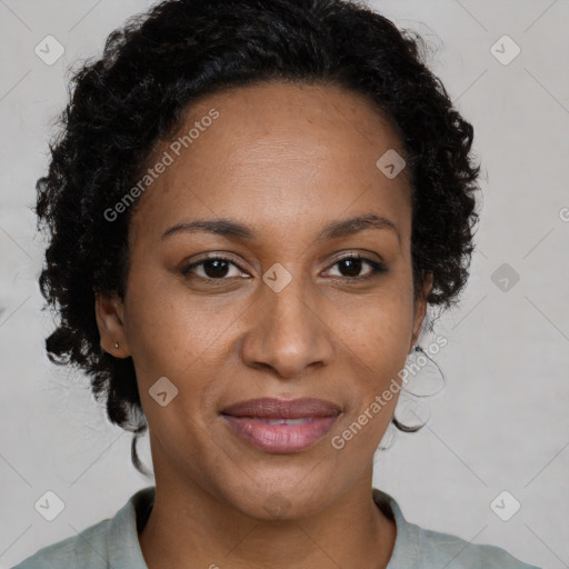 Joyful black adult female with medium  brown hair and brown eyes