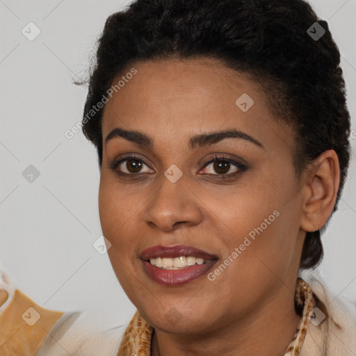 Joyful black young-adult female with long  brown hair and brown eyes