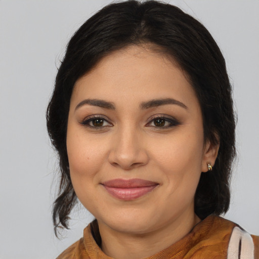 Joyful latino young-adult female with medium  brown hair and brown eyes