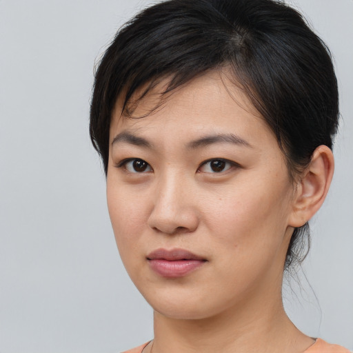 Joyful asian young-adult female with medium  brown hair and brown eyes