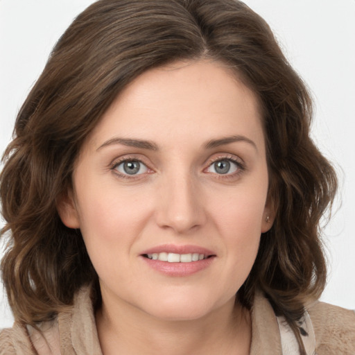 Joyful white young-adult female with medium  brown hair and blue eyes