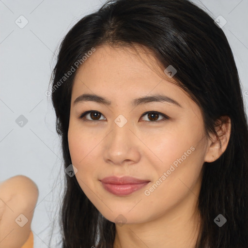 Joyful latino young-adult female with long  brown hair and brown eyes