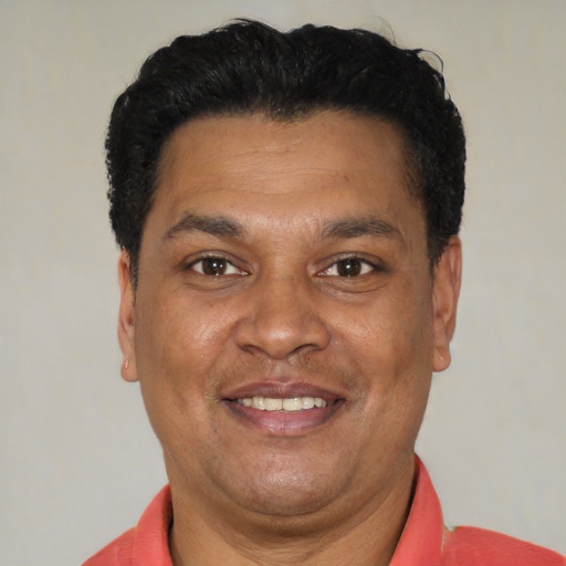Joyful latino adult male with short  black hair and brown eyes