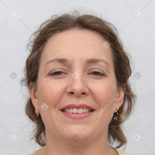 Joyful white adult female with medium  brown hair and grey eyes