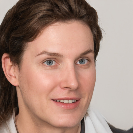 Joyful white young-adult female with medium  brown hair and blue eyes