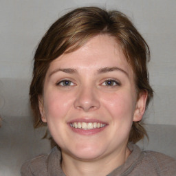 Joyful white young-adult female with medium  brown hair and blue eyes