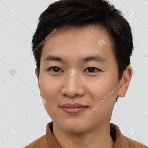 Joyful asian young-adult male with short  brown hair and brown eyes