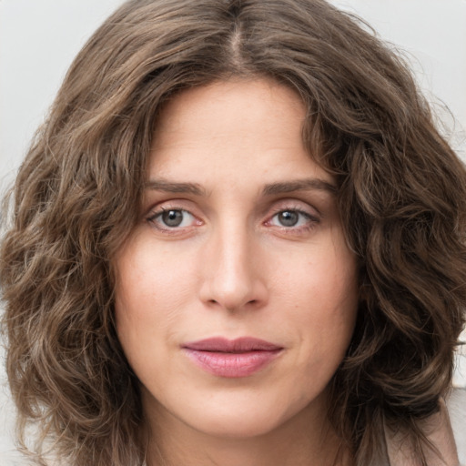 Joyful white young-adult female with long  brown hair and green eyes