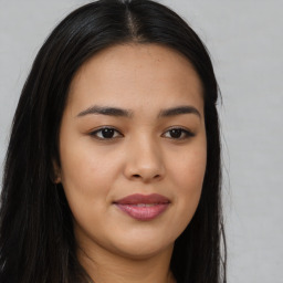 Joyful asian young-adult female with long  brown hair and brown eyes