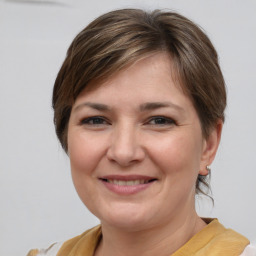 Joyful white young-adult female with medium  brown hair and brown eyes