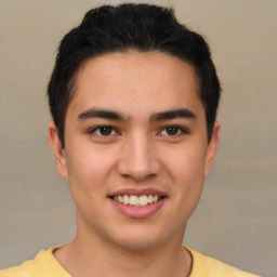 Joyful latino young-adult male with short  brown hair and brown eyes