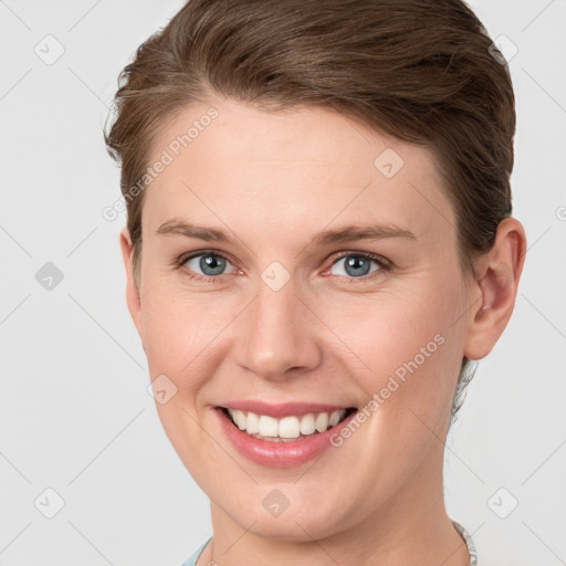 Joyful white young-adult female with medium  brown hair and grey eyes