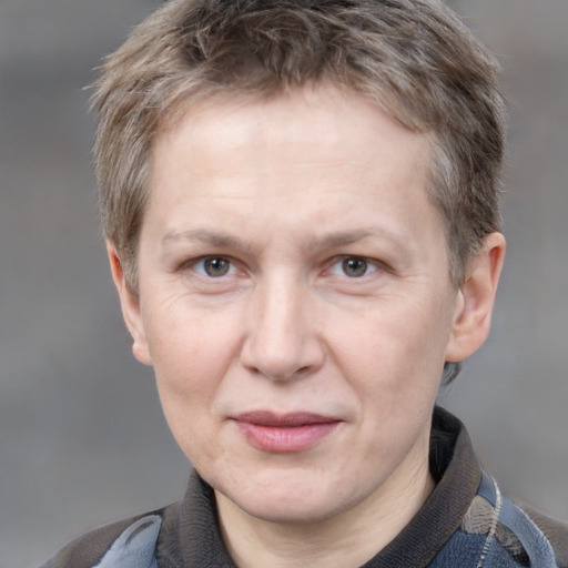 Joyful white adult female with short  brown hair and grey eyes