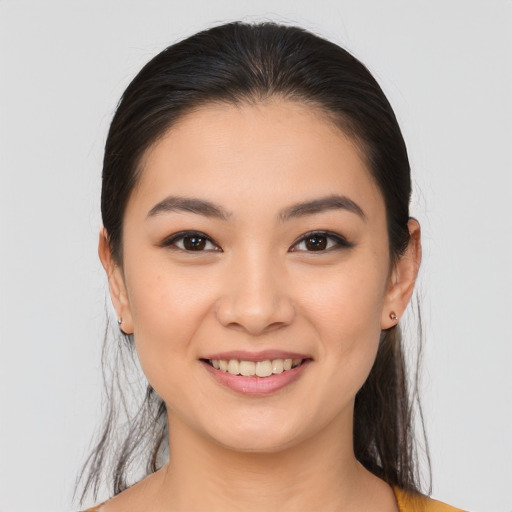 Joyful asian young-adult female with medium  brown hair and brown eyes