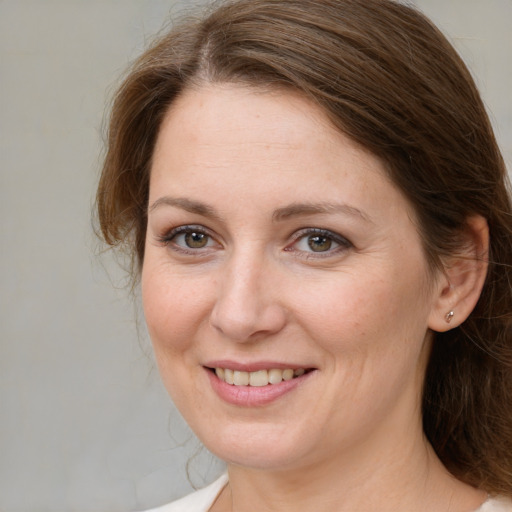 Joyful white young-adult female with medium  brown hair and brown eyes