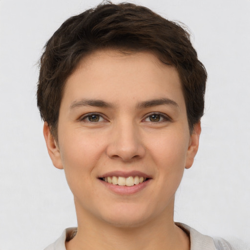 Joyful white young-adult female with short  brown hair and brown eyes