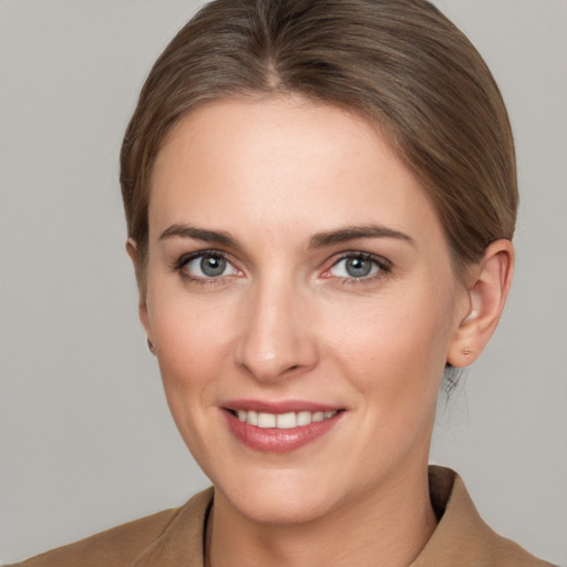 Joyful white young-adult female with medium  brown hair and grey eyes