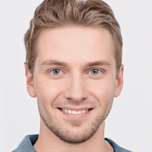 Joyful white young-adult male with short  brown hair and blue eyes