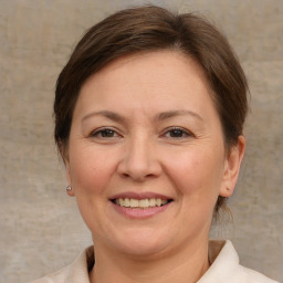 Joyful white adult female with medium  brown hair and brown eyes