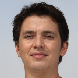 Joyful white adult male with short  brown hair and brown eyes