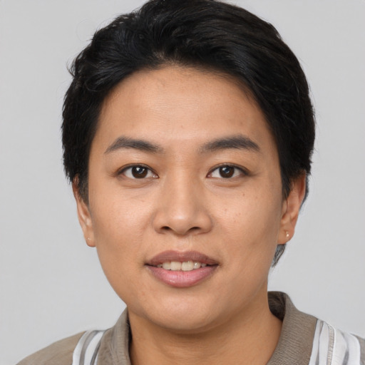 Joyful asian young-adult female with short  black hair and brown eyes