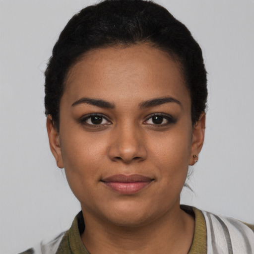 Joyful latino young-adult female with short  black hair and brown eyes