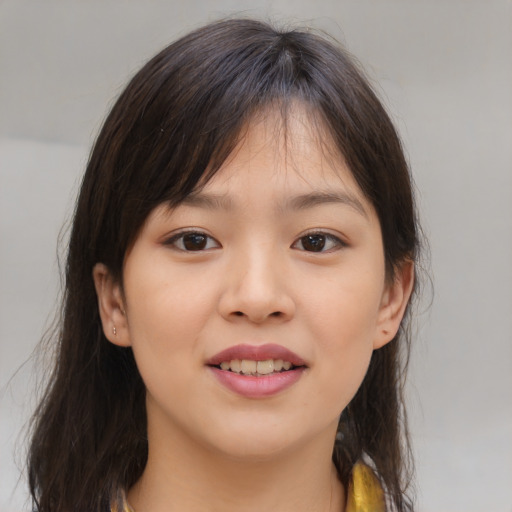 Joyful asian child female with medium  brown hair and brown eyes