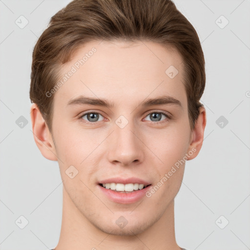 Joyful white young-adult male with short  brown hair and grey eyes