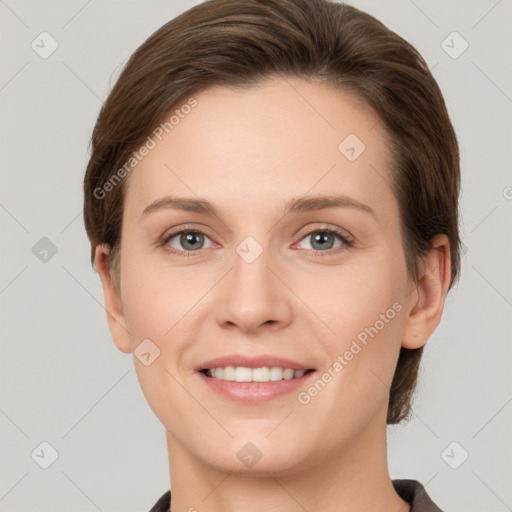 Joyful white young-adult female with short  brown hair and grey eyes