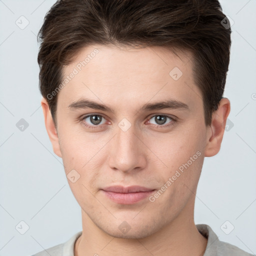 Joyful white young-adult male with short  brown hair and grey eyes