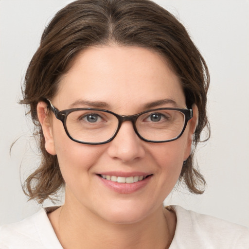 Joyful white young-adult female with medium  brown hair and grey eyes