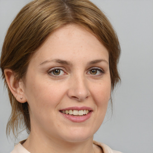 Joyful white young-adult female with medium  brown hair and brown eyes