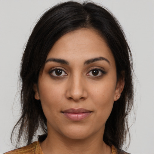 Joyful latino young-adult female with long  brown hair and brown eyes