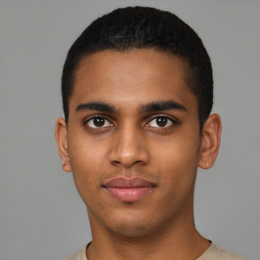 Joyful latino young-adult male with short  brown hair and brown eyes