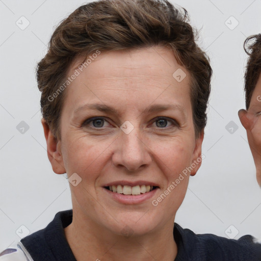 Joyful white adult female with short  brown hair and grey eyes