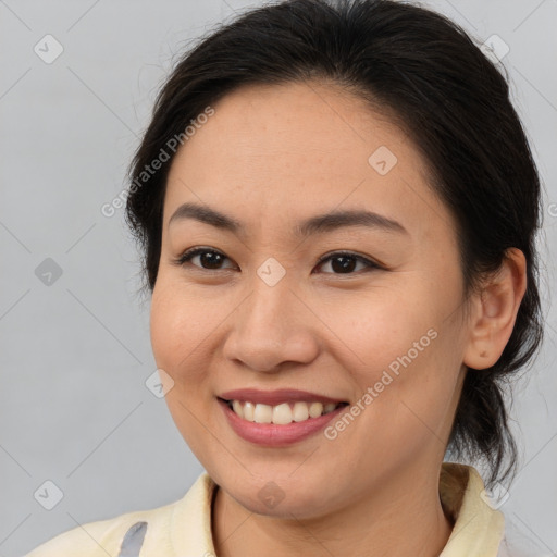 Joyful latino young-adult female with medium  brown hair and brown eyes