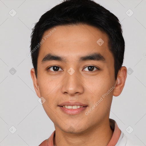 Joyful latino young-adult male with short  black hair and brown eyes