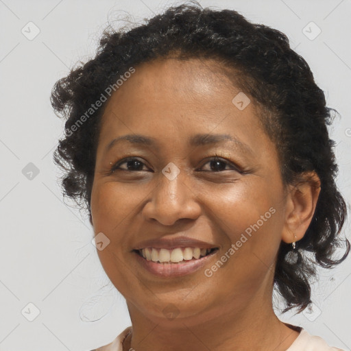 Joyful black adult female with medium  brown hair and brown eyes