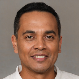 Joyful white adult male with short  black hair and brown eyes