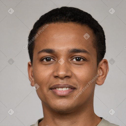 Joyful black young-adult male with short  black hair and brown eyes