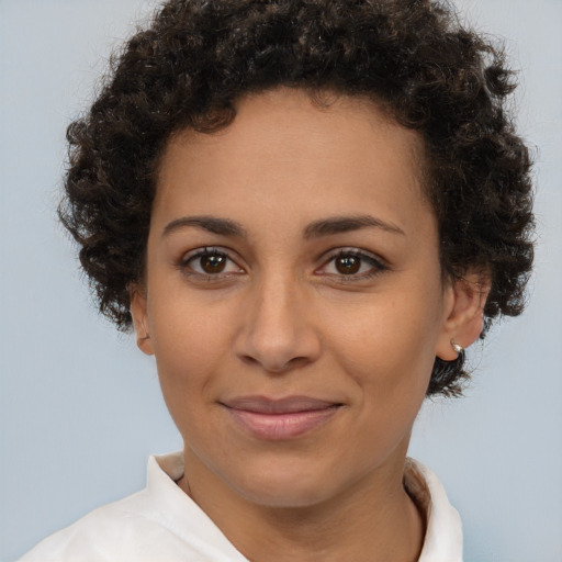 Joyful latino young-adult female with short  brown hair and brown eyes