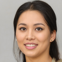 Joyful asian young-adult female with long  brown hair and brown eyes