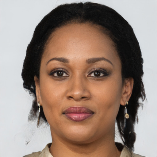 Joyful black adult female with medium  black hair and brown eyes