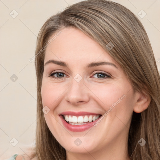 Joyful white young-adult female with long  brown hair and grey eyes