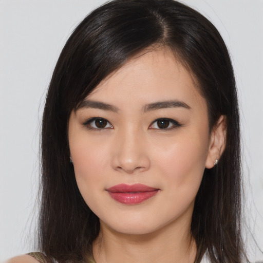 Joyful asian young-adult female with long  brown hair and brown eyes