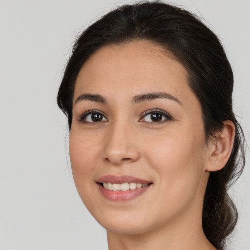 Joyful white young-adult female with long  brown hair and brown eyes